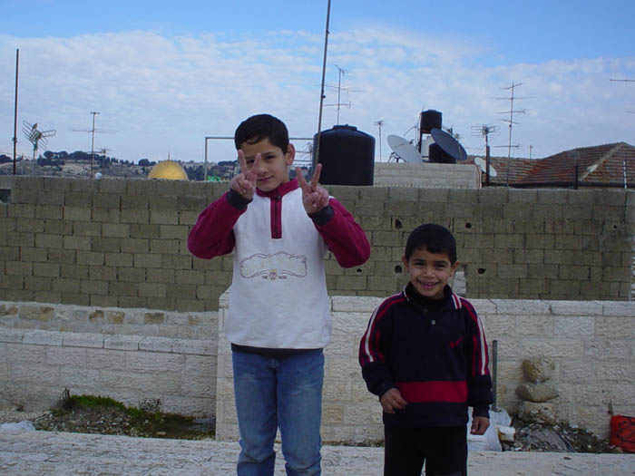 Arab kids in Jerusalem offering the peace symbol
